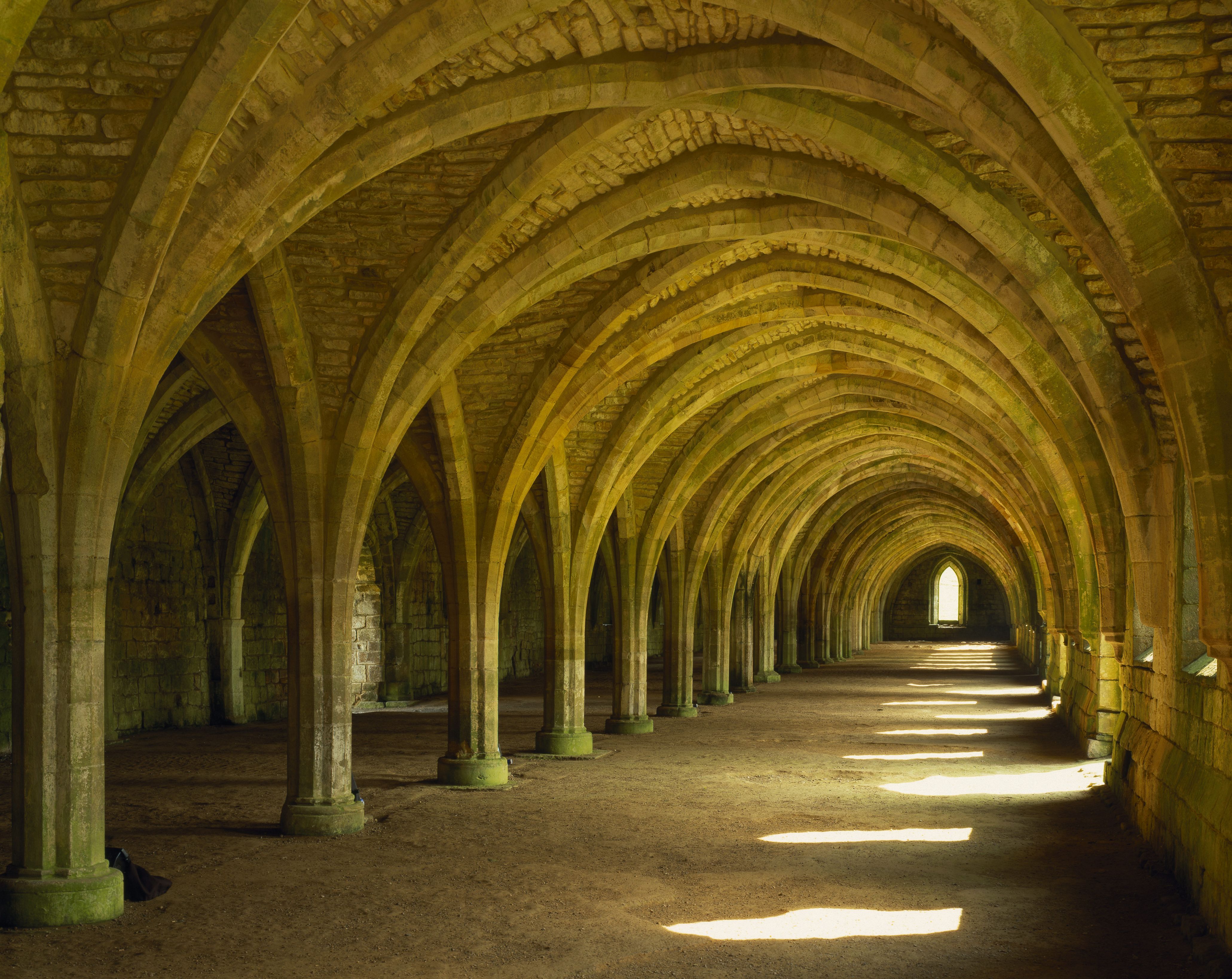 The magnificent West Range of the Cloisters at Fountains Abbey, North Yorkshire, containing the cellarium and lay brothers' refectory.