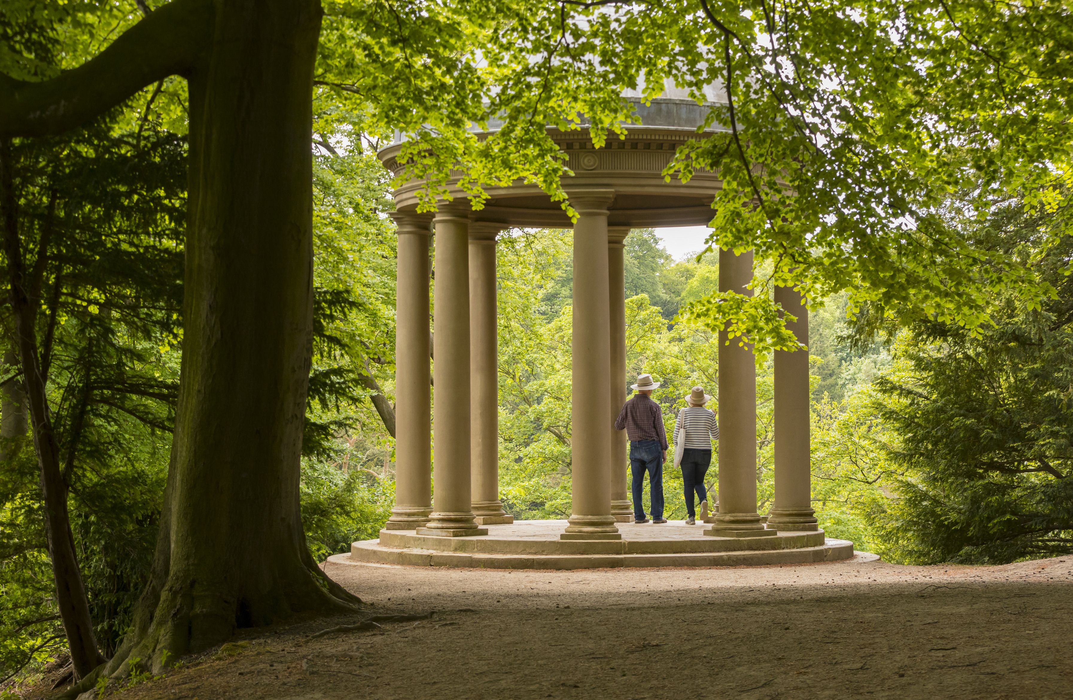 Visitors at the Temple of Fame in the grounds of Fountains Abbey and Studley Royal Water Garden, North Yorkshire